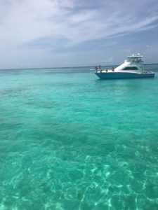 This picture is of the boat and then also the blue water for as far as you can see. 