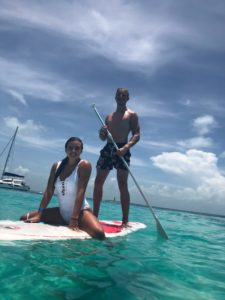 This picture is of us paddle boarding. You can see the blue water again and also another boat in the background. 