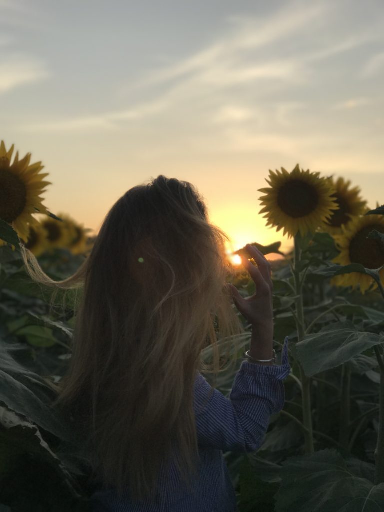 Photo of me enjoying Kansas' beauty in a sunflower field. 