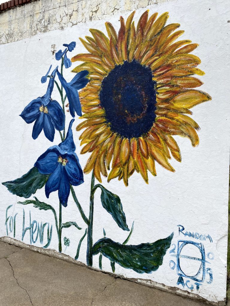 A painting of a sunflower on a wall in Hays.